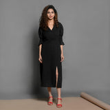 Front View of a Model wearing Black Handspun Cotton Pleated Midi Slit Dress