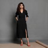 Front View of a Model wearing Black Handspun Cotton Pleated Midi Slit Dress