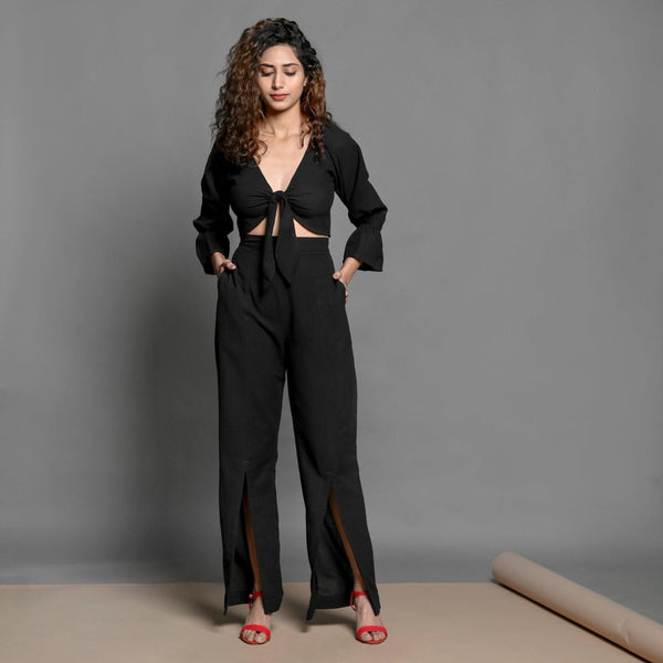 Front View of a Model wearing Black Tie-up Crop Top and Slit Pant Set