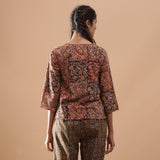 Back View of a Model wearing Muddy Red Kalamkari Raglan Sleeves Top