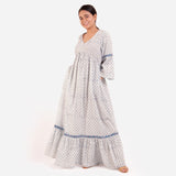 Left View of a Model wearing Blue Block Printed Bell Sleeves Tier Dress