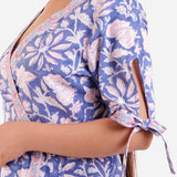 Left Detail of a Model wearing Blue Plunge Neck Floral Wrap Dress