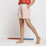 Left View of a Model wearing Vegetable Dyed Off-White Paneled Shorts