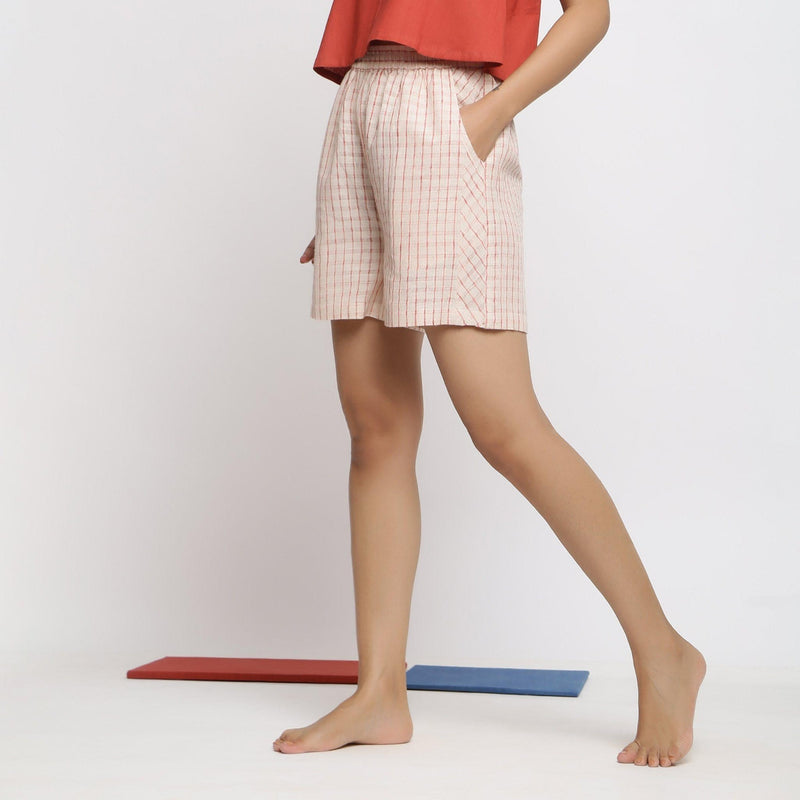 Left View of a Model wearing Vegetable Dyed Off-White Paneled Shorts