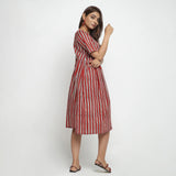 Right View of a Model wearing Brick Red Bagru Asymmetrical Midi Dress