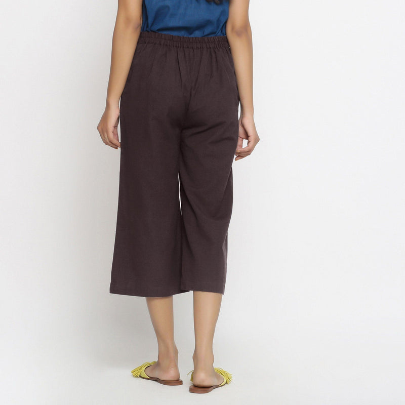 Back View of a Model wearing Brown Mid-Rise Cotton Flax Culottes