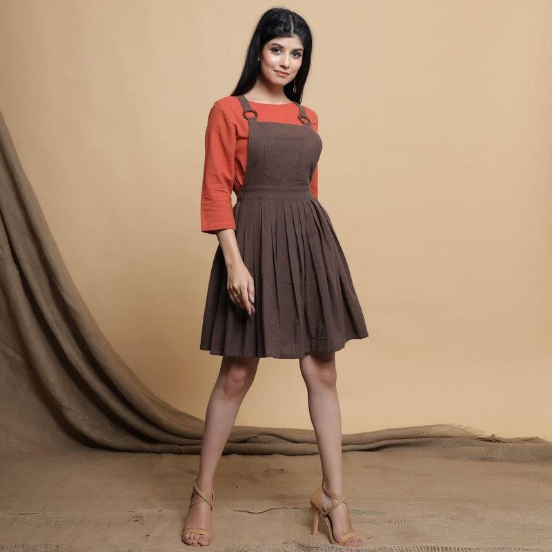 Front View of a Model wearing Brown Pleated Criss-Cross Back Dress