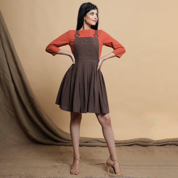 Front View of a Model wearing Brown Pleated Criss-Cross Back Dress