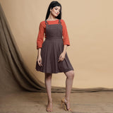 Front View of a Model wearing Brown Pleated Cotton Flax Knee Length Criss-Cross Back Dress