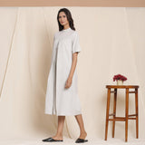 Left View of a Model wearing Cotton Cloudy Grey Box Pleated Jumpsuit