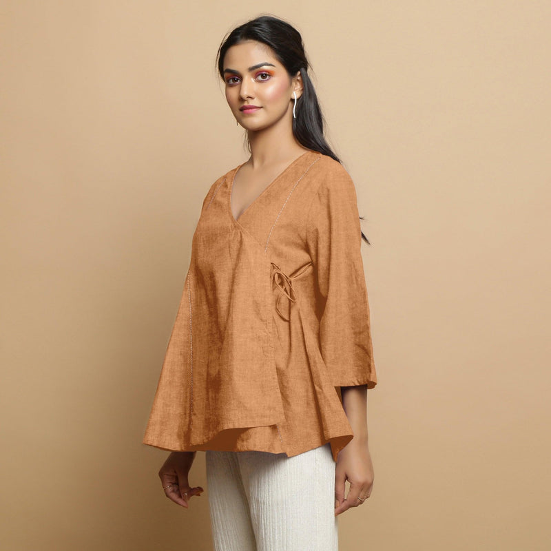 Left View of a Model wearing Desert Yellow 100% Linen Asymmetrical Godet Top