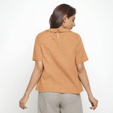 Back View of a Model wearing Desert Yellow 100% Linen Peter Pan Collar Top