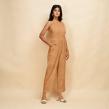 Right View of a Model wearing Desert Yellow 100% Linen Princess Line Sleeveless Jumpsuit