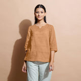 Front View of a Model wearing Desert Yellow 100% Linen Split-Neck Tunic Top