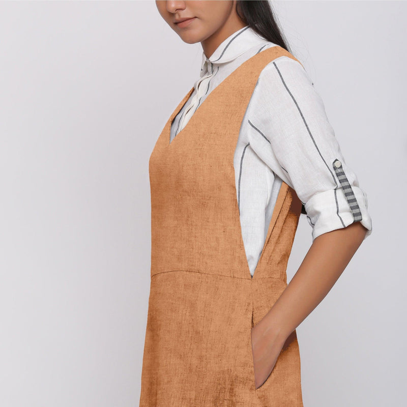 Left Detail of a Model wearing Desert Yellow 100% Linen V-Neck Midi Pinafore Dress