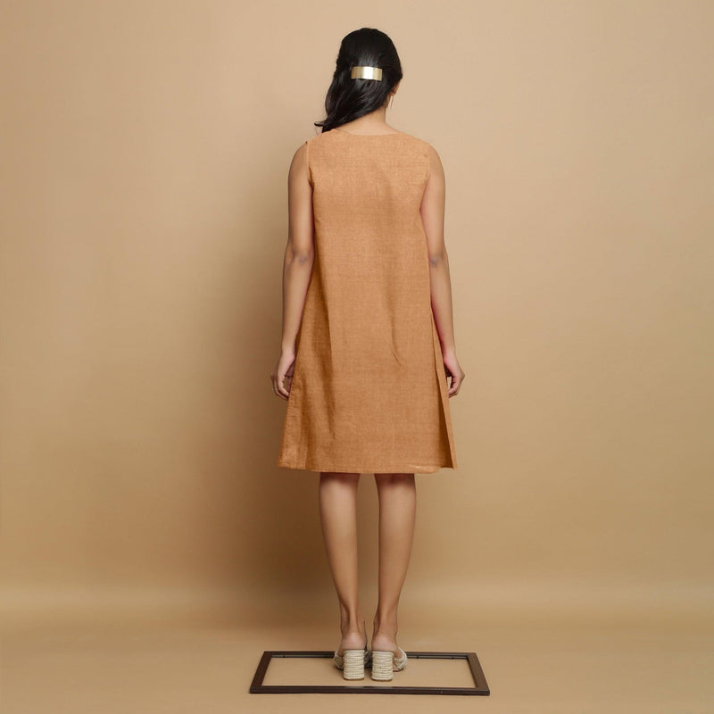 Back View of a Model wearing Desert Yellow Linen Embroidered Knee-Length Godet Dress