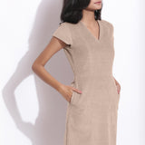 Front Detail of a Model wearing Dusk Beige Cotton Corduroy V-Neck Dress