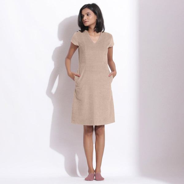 Front View of a Model wearing Dusk Beige Cotton Corduroy V-Neck Dress