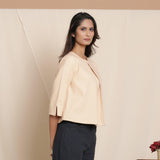 Right View of a Model wearing Warm Flannel Dusk Beige Box-Pleat Top