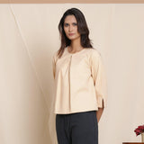 Left View of a Model wearing Warm Flannel Dusk Beige Box-Pleat Top