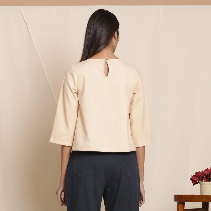 Back View of a Model wearing Warm Flannel Dusk Beige Box-Pleat Top