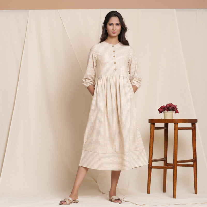 Front View of a Model wearing Dusk Beige Warm Cotton Striped Gathered Midi Dress