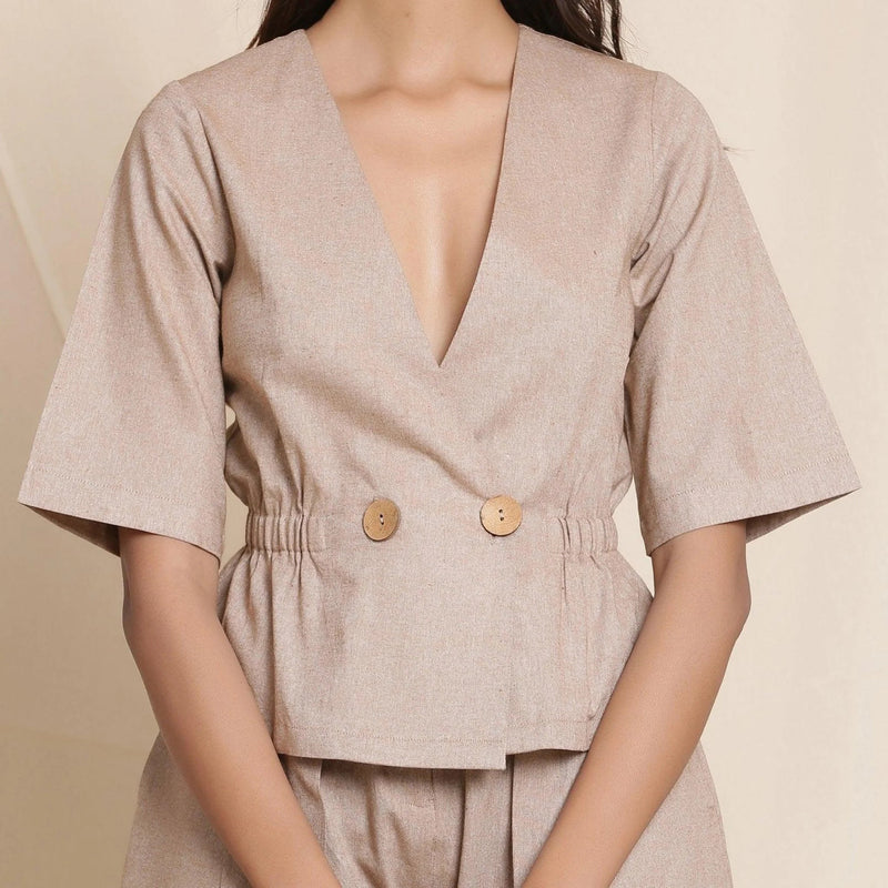 Front Detail of a Model wearing Dusk Beige Plunge Neck Peplum Top