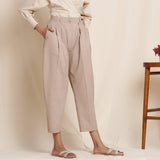 Right View of a Model wearing Dusk Brown Box Pleated Pegged Pant