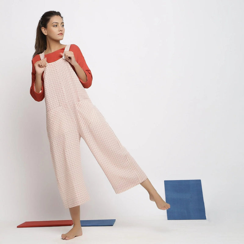 Front View of a Model wearing Ecru and Brick Red Striped Vegetable Dyed Cotton Pinafore Jumpsuit