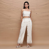 Front View of a Model wearing Ecru Jute Laced Cotton Muslin Mid-Rise Elasticated Pant