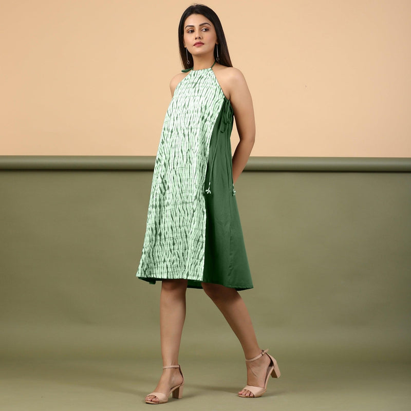 Left View of a Model wearing Dark Green Green Shibori Halter Neck A line Dress