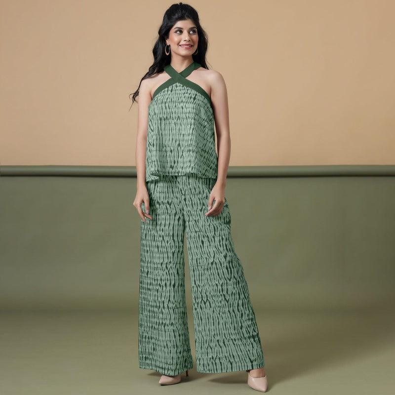 Front View of a Model wearing Dark Green Shibori Halter Neck Flared Top