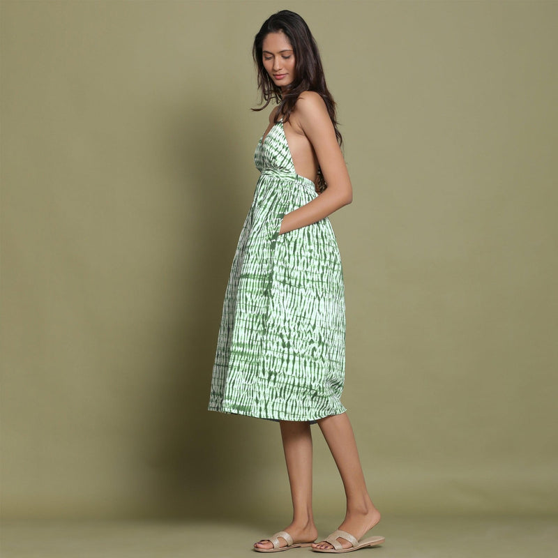 Left View of a Model wearing Dark Green Shibori Halter Neck Gathered Dress