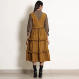 Back View of a Model wearing Golden Oak Tier Pinafore Frilled Dress