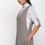 Left Detail of a Model wearing Grey Handspun Deep V-Neck Pinafore Dress