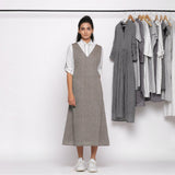 Front View of a Model wearing Grey Handspun Deep V-Neck Pinafore Dress