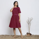 Front View of a Model wearing Handspun Maroon Backless Fit and Flare Dress