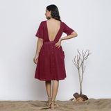 Back View of a Model wearing Handspun Maroon Backless Fit and Flare Dress