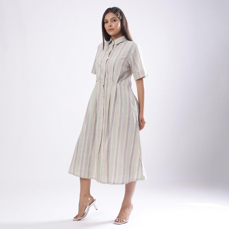 Left View of a Model wearing Handspun Cotton Muslin Button-Down Shirt Dress