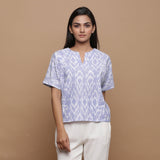 Front View of a Model wearing Ikat Powder Blue Split Neck Top