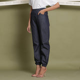 Left View of a Model wearing Indigo Cotton Denim Elasticated Mid-Rise Jogger Pant