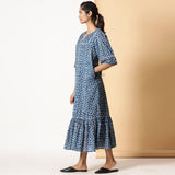 Left View of a Model wearing Breezy Cotton Indigo Dabu Maxi Tier Dress