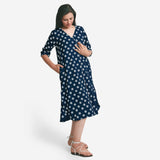 Right View of a Model wearing Indigo Polka Dot Plunge Neck Dress