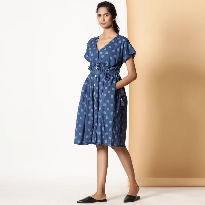 Left View of a Model wearing Indigo Dabu Block Printed Polka Dot Frilled Dress