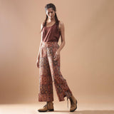 Left View of a Model wearing Muddy Red Wide-Leg Kalamkari Slit Pant