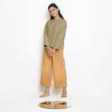 Left View of a Model wearing Vegetable-Dyed Green 100% Cotton Straight Top