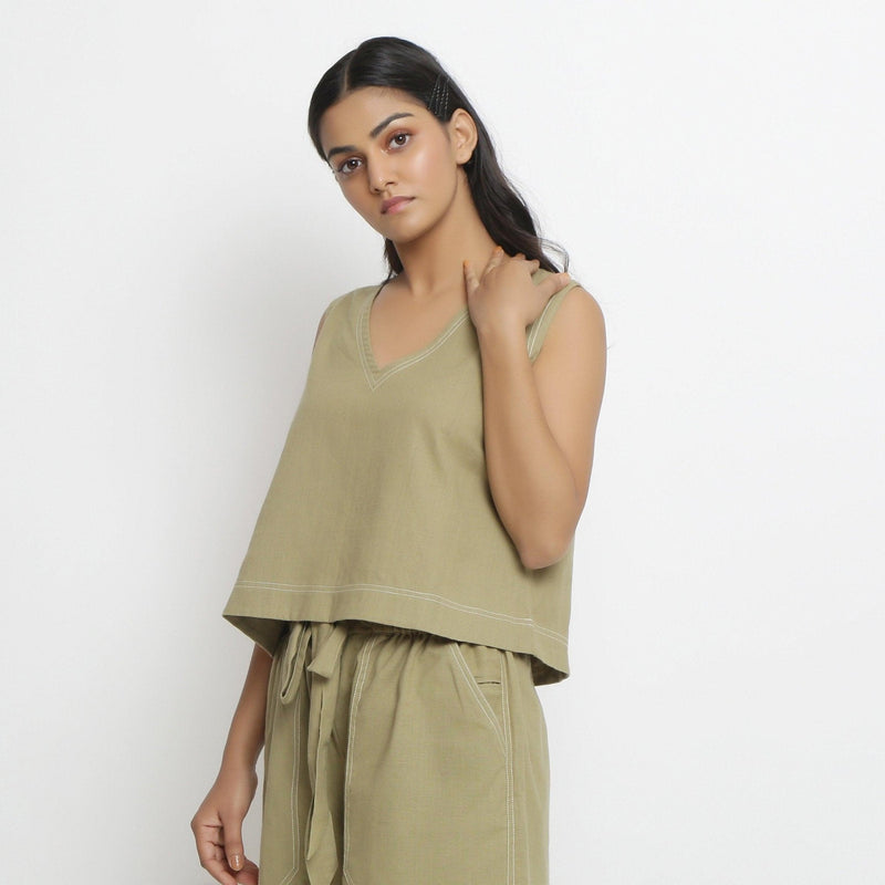 Left View of a Model wearing Khaki Green Vegetable Dyed Handspun Cotton Sleeveless Crop Top