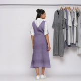 Back View of a Model wearing Lavender 100% Linen V-Neck Midi Pinafore Dress