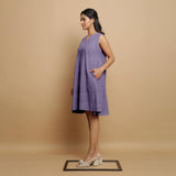 Left View of a Model wearing Lavender Linen Embroidered Knee-Length Godet Dress