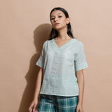 Front View of a Model wearing Light Green Checks Handspun Cotton Muslin V-Neck Top